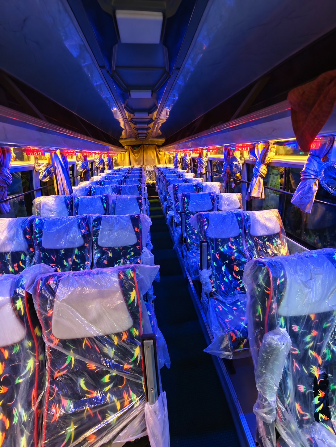 Empty passenger seats inside Pari Pallavi coach at night